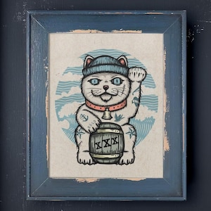 May include: A white cat with blue sailor hat and tattoos holding a barrel with the word "XXX" on it. The cat is sitting on a blue and white wave background.