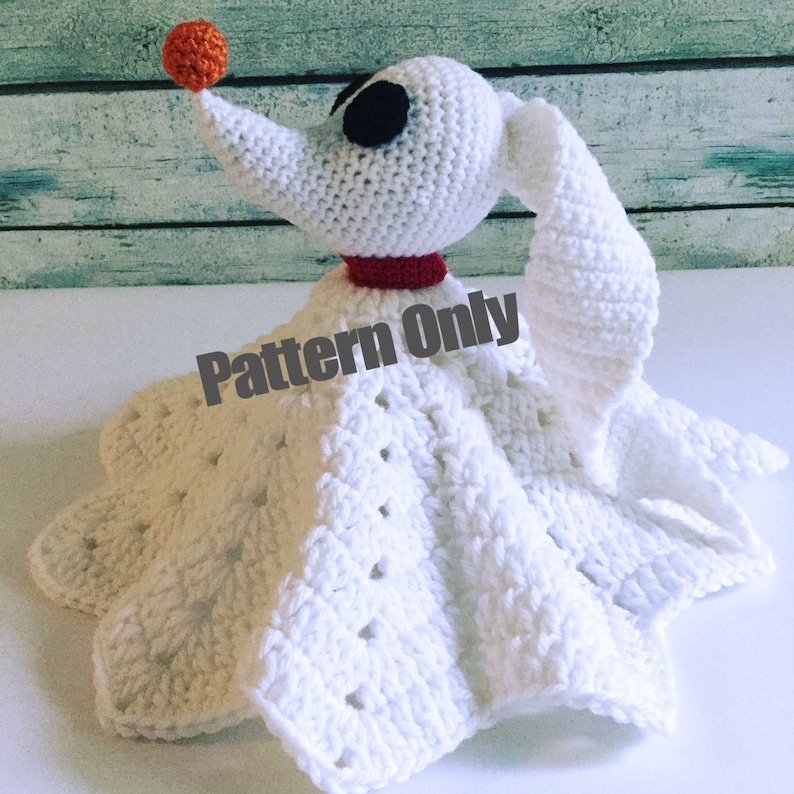 May include: White crochet amigurumi pattern for a Zero the Ghost Dog from Nightmare Before Christmas. The pattern includes a red collar and an orange nose.