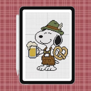 May include: A digital cross-stitch pattern displayed on a tablet screen featuring a white cartoon dog wearing a green hat with a feather and brown lederhosen. The dog holds a foamy beer mug in one hand and a large golden-brown pretzel in the other.