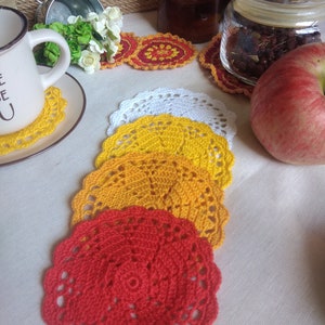 Set of four colorful crocheted cotton coasters for hot and cold beverages