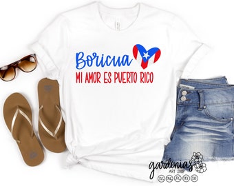May include: White t-shirt with blue text that says "Boricua Mi Amor Es Puerto Rico" and a red heart with the Puerto Rican flag inside.