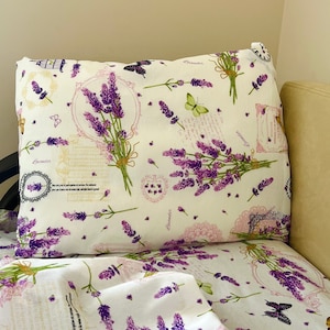 May include: White bedding with a lavender floral pattern. The bedding features a pillow with a lavender bouquet design and the word "Lavender" repeated throughout.