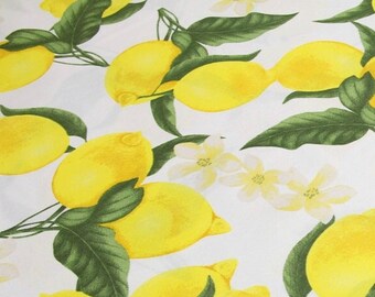 May include: A white background with a repeating pattern of yellow lemons and green leaves. The lemons are arranged in a random pattern and some are partially obscured by the leaves.