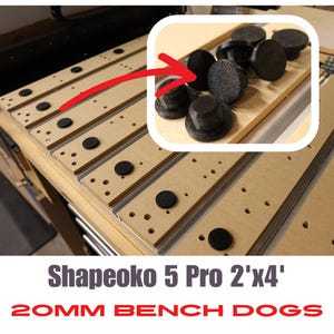 May include: Close-up of black 20mm bench dogs for a Shapeoko 5 Pro 2'x4' CNC machine. The bench dogs are made of a durable plastic material and have a textured surface for a secure grip.