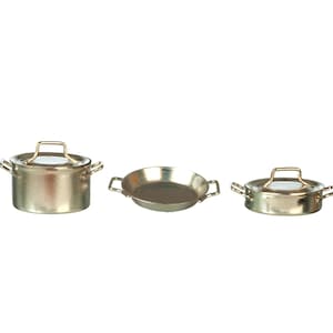May include: A set of three miniature metallic cooking vessels including a deep pot with a lid, a shallow open pan, and a low-profile pot with a lid. Each piece features two small side handles and a polished gold-tone finish.