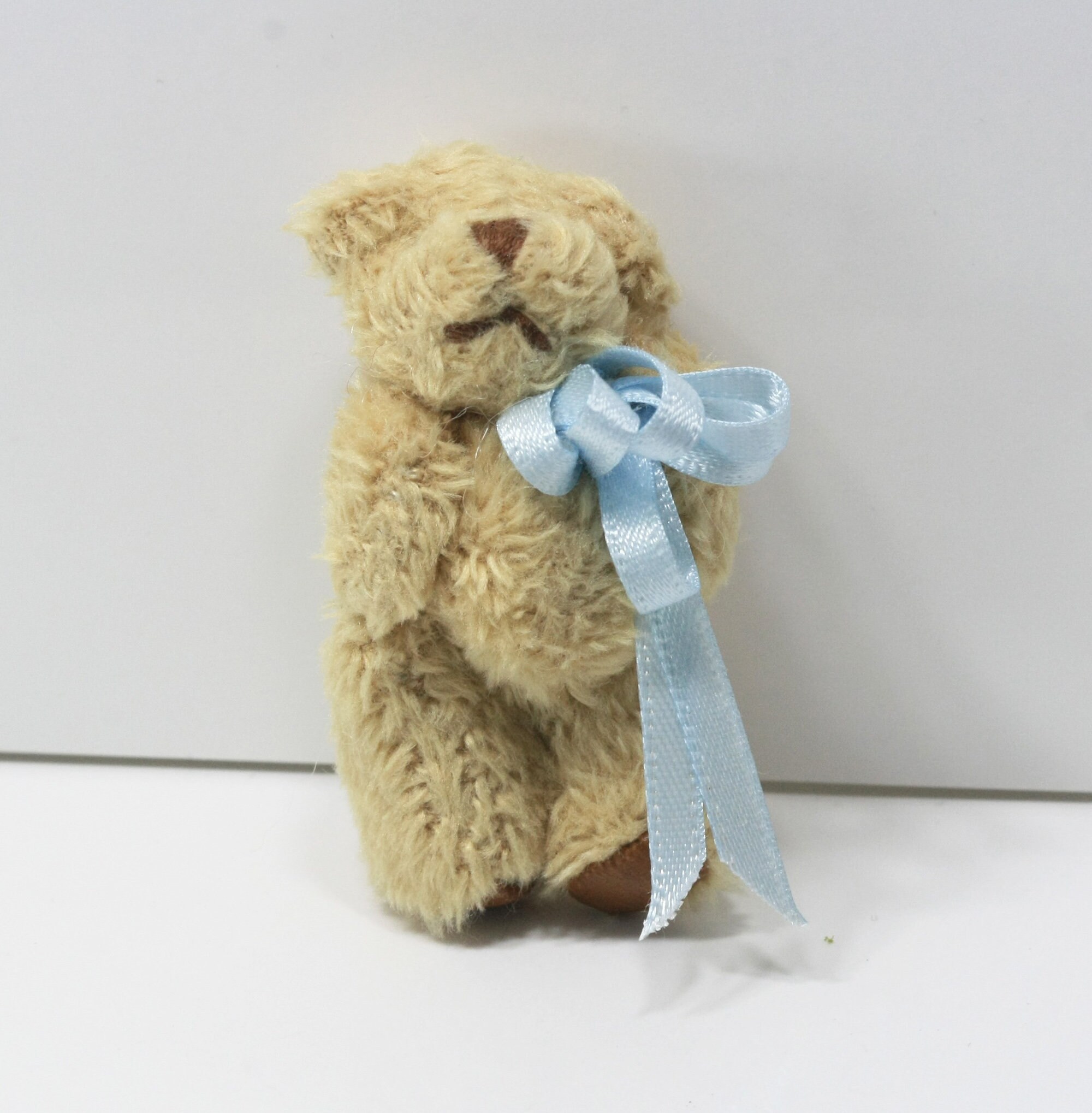 Teddy bear with blue ribbon shop