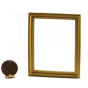 May include: A small, rectangular gold-colored picture frame with a beaded border. The frame is empty, with a white background visible through the opening. A penny is next to the frame for size comparison.