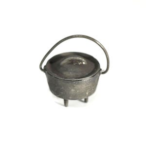 May include: A small, cast iron pot with a lid and a curved handle. The pot has three short legs and a dark gray color. The handle arches over the top of the pot.