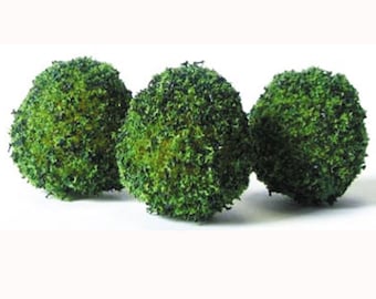 May include: Three artificial green moss balls with a textured surface are arranged against a white background. These decorative spheres are ideal for adding a natural touch to floral arrangements, centerpieces, or craft projects.