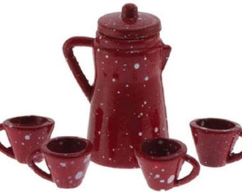 May include: A miniature red enamel coffee pot with a matching lid and handle, accompanied by three small matching cups. The set features a speckled white pattern, creating a rustic, vintage aesthetic. Ideal for dollhouses or miniature collections.