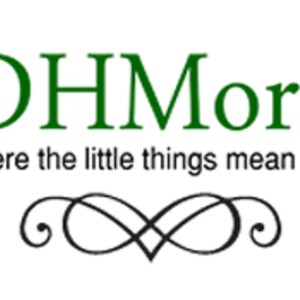May include: The image features the text "DHMore" in green, above the phrase "where the little things mean a lot." A black decorative swirl design is below the text. The background is white.