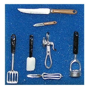 May include: Miniature kitchen tools set on a blue surface. Includes a large knife, a small knife, a spatula, a meat grinder, a potato masher, a peeler, and a slotted spatula. The tools have black and brown handles.