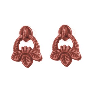 May include: Pair of reddish-brown earrings. Each earring features a circular top, a decorative ring, and a floral-shaped bottom with leaf details. The earrings are set against a white background.