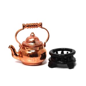 May include: A white ceramic mug with a black handle and the text "But First, Coffee" in a bold, black font. The mug is set against a blurred background, suggesting a cozy setting.