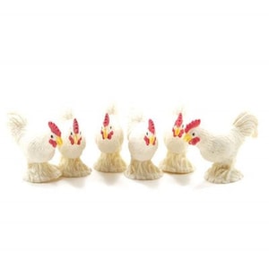 May include: A collection of six white chicken figurines with red combs and yellow beaks. The chickens have a textured, fluffy appearance and are arranged in a row. The figurines are likely decorative items.