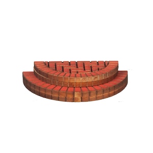 May include: A two-tiered, semi-circular decorative brick structure. The bricks are a reddish-brown color with a lighter wood-toned border. The structure is designed to resemble a miniature staircase or platform.