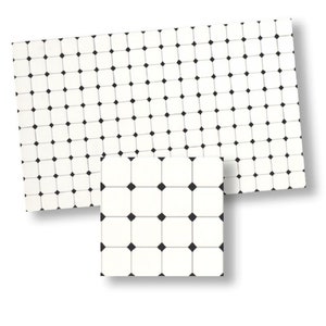 May include: Two white rectangular mats with a repeating pattern of black squares and black diamond shapes. The mats are of different sizes, with the smaller one in the foreground.