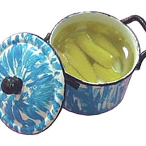 May include: A blue and white enamelware pot with a lid, containing pickles in brine. The pot has black handles and a matching lid with a black knob. The design features a blue and white swirled pattern.