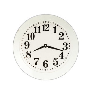 May include: A white clock face with black numerals and hands. The clock shows the time as approximately 8:18. The clock face has a simple, classic design, with a white background and a black border.