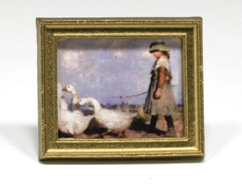 May include: Miniature framed painting depicting a young person leading three white geese. The artwork has a pastoral theme, with a muted color palette and a gold-colored frame. The painting evokes a sense of nostalgia.