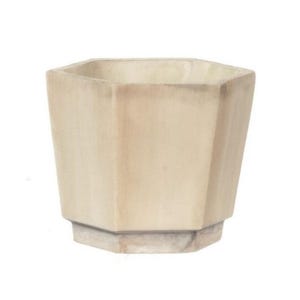 May include: A beige, geometric planter with a hexagonal top and base. The planter has a tapered design and is made of a light-colored material, possibly concrete or stone. The neutral color and shape make it suitable for various plants and decor styles.
