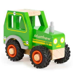 May include: A green wooden toy tractor with black wheels and a name tag that says "Matthew".