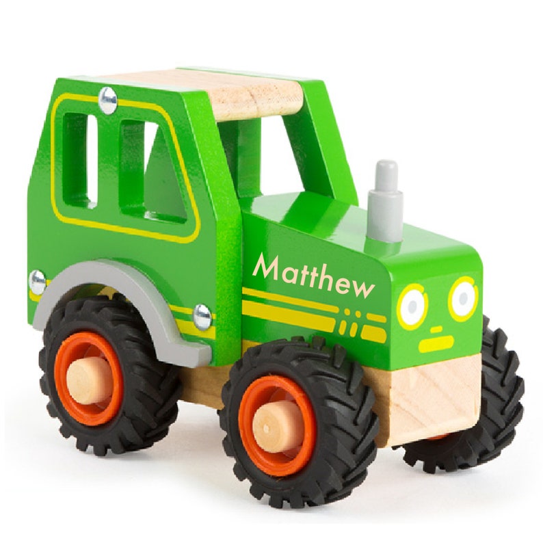 May include: A green wooden toy tractor with black wheels and a name tag that says "Matthew".