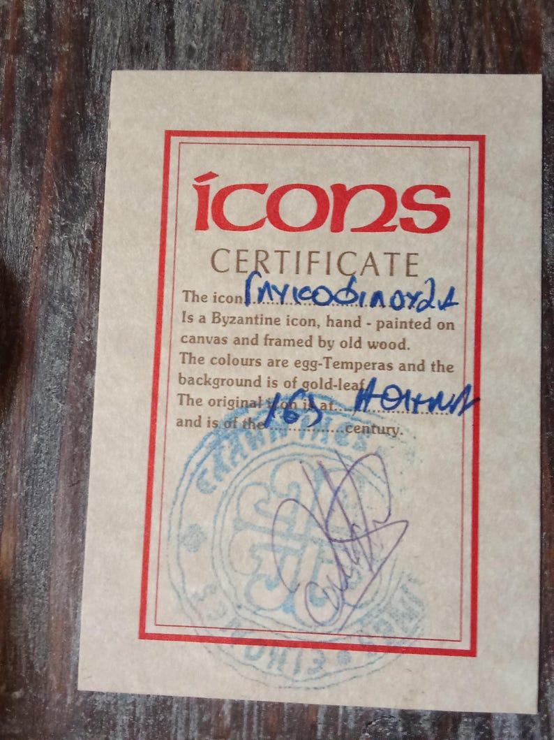 May include: A rectangular certificate of authenticity for a Byzantine icon, printed on light beige paper with a red border. The text reads "icons CERTIFICATE" and includes handwritten blue ink details, a circular blue stamp, and a signature at the bottom.