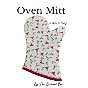 May include: White quilted oven mitt with a pattern of red cardinals, green sprigs, and red berries. The mitt has a red trim and the words "Oven Mitt" and "Quick & Easy" are printed on the image.