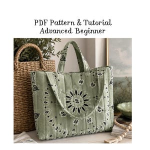 May include: A quilted tote bag in sage green with a black bandana-style paisley print. The bag features two top handles and vertical stitching. Text above the bag reads: PDF Pattern & Tutorial Advanced Beginner.