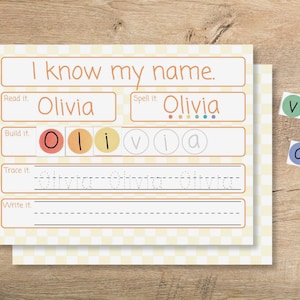 May include: A learning worksheet with the text "I know my name." The worksheet includes sections to read, spell, build, trace, and write the name "Olivia." Colorful letter tiles are included.