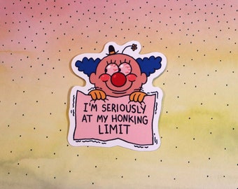 May include: A sticker featuring a cartoon clown with blue hair and a red nose holding a sign that says "I'm seriously at my honking limit".