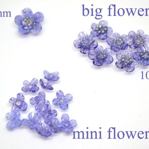 May include: Purple plastic flower beads in three sizes: 12mm, 10mm, and smaller.  The beads are translucent and have a shiny finish.  The text "big flowers" and "mini flowers" is included in the image.
