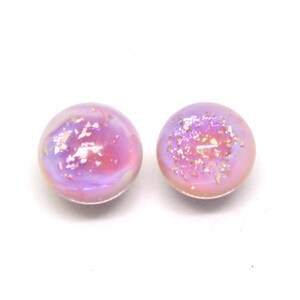 May include: A pair of iridescent purple and pink glass earrings with gold flecks.