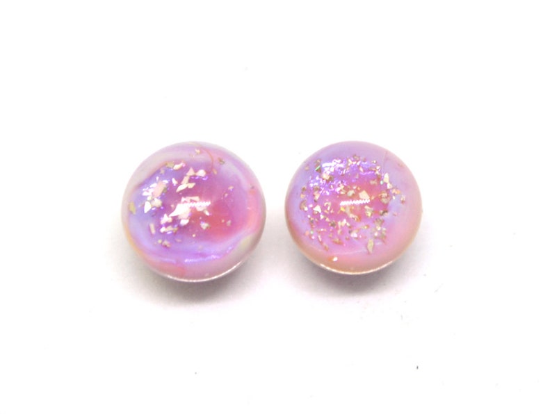 May include: A pair of iridescent purple and pink glass earrings with gold flecks.