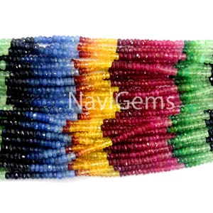 May include: A strand of colourful gemstone beads, including red ruby, green emerald, blue sapphire, and yellow citrine. The beads are faceted and have a smooth, polished finish.
