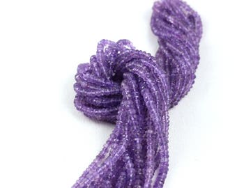 May include: A strand of purple amethyst beads, faceted and round, strung together for jewelry making.