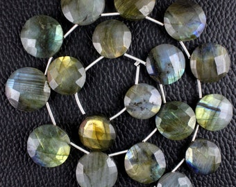 May include: A strand of faceted labradorite gemstone beads in shades of green, blue, and gold. The beads are round and have a smooth, polished finish.