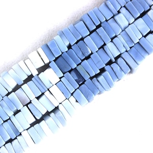 May include: A strand of light blue and white opal beads, each bead is rectangular and has a slightly irregular shape.