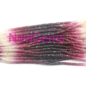 May include: A strand of faceted gemstone beads in shades of pink, white, and dark red. The beads are graduated in size, with the largest beads at the centre of the strand and the smallest beads at the ends.