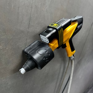 May include: A black and yellow paint sprayer with a black light attached to it. The sprayer is labeled "Gama".