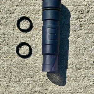 May include: A dark blue plastic tube with black rings and two black rubber o-rings.
