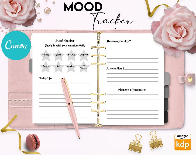 May include: A pink and white planner with a gold spiral binding. The cover says "MOOD Tracker" and has a pink rose on the right side. The inside pages have lines for writing and a section for tracking moods with stars.