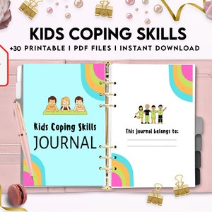 May include: A pink binder with a colorful journal inside. The journal cover features a rainbow design and the text "Kids Coping Skills JOURNAL".
