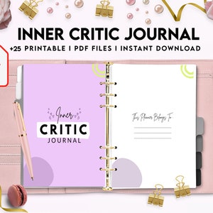 May include: A pink and white journal with the text "Inner Critic Journal" on the cover. The journal has a gold spiral binding and is open to a page with the text "This Planner Belongs To".