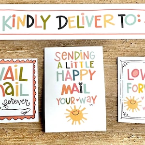 May include: A collection of colorful paper cards with handwritten text and illustrations. The cards include phrases like "Kindly Deliver To:" and "Snail Mail forever." Other cards say "Sending a Little Happy Mail Your Way" and "Love It Forward."