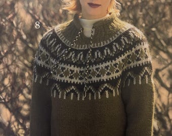 May include: An olive green knit sweater and matching beanie with a geometric pattern in white, black, and olive green. The sweater has a high collar with a drawstring and two front pockets. The number "8" is visible in the image.