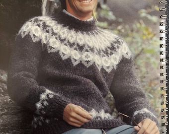 May include: A dark gray and white patterned sweater with a high neckline. The sweater features a geometric design around the yoke and cuffs. The image also shows a person wearing the sweater, holding glasses.