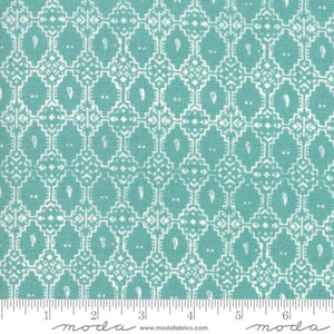 May include: Teal fabric with a white geometric pattern. The pattern features small white paisley shapes and a repeating grid of squares. The fabric is labeled "moda" in white text.
