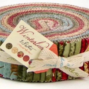 May include: A roll of fabric scraps in a variety of colors and patterns, including red, green, blue, and white. The fabric is tied with a white ribbon and labeled "Winterlua 36 Strips Moda".
